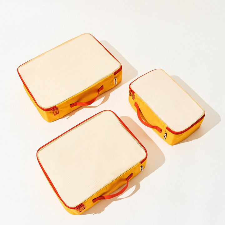 3 sizes of sunrise yellow Cram packing cubes suitcase organizers flat view