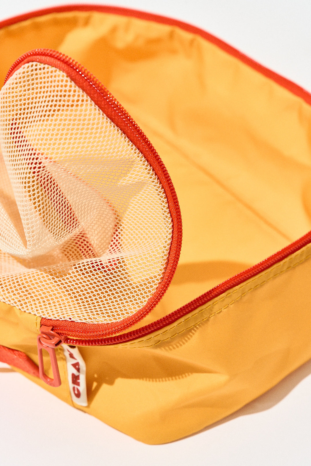 Close up of open sunrise yellow Cram packing cubes suitcase organizer zip detail showing inside