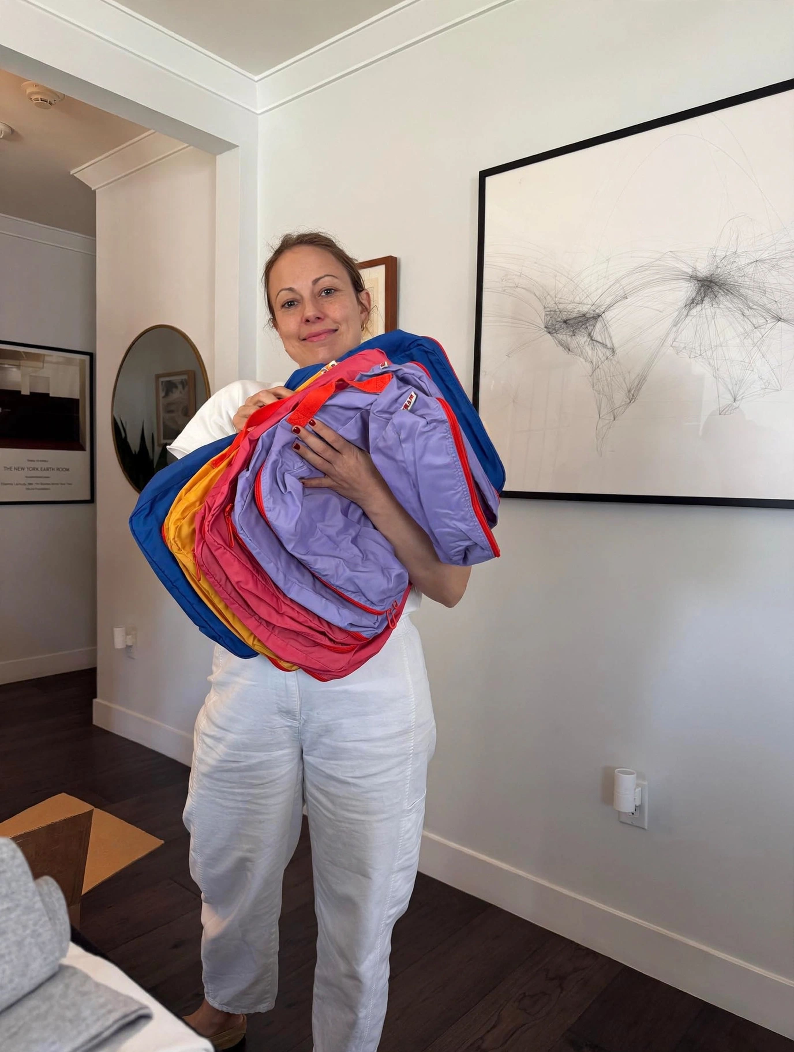 Cram Founder holding four colorful packing cubes