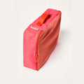Bloom pink Cram Medium packing cube standing upright, with a mesh side and red zipper