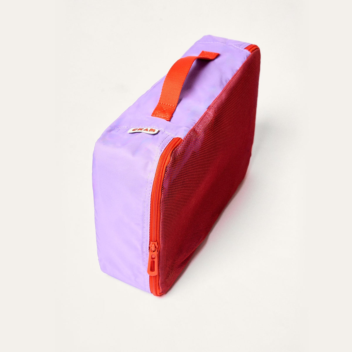 Twilight purple Cram Medium packing cube standing upright, with a red mesh side and red zipper