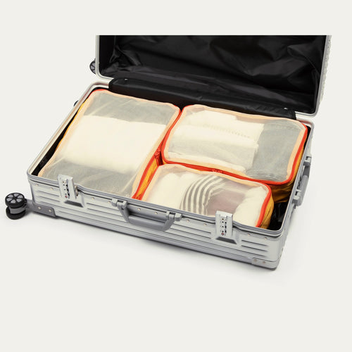Sunrise yellow Cram packing cubes packed in an open suitcase